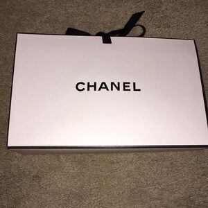 Authentic Chanel gift bag with black ribbon tie. Measures  9x6x3